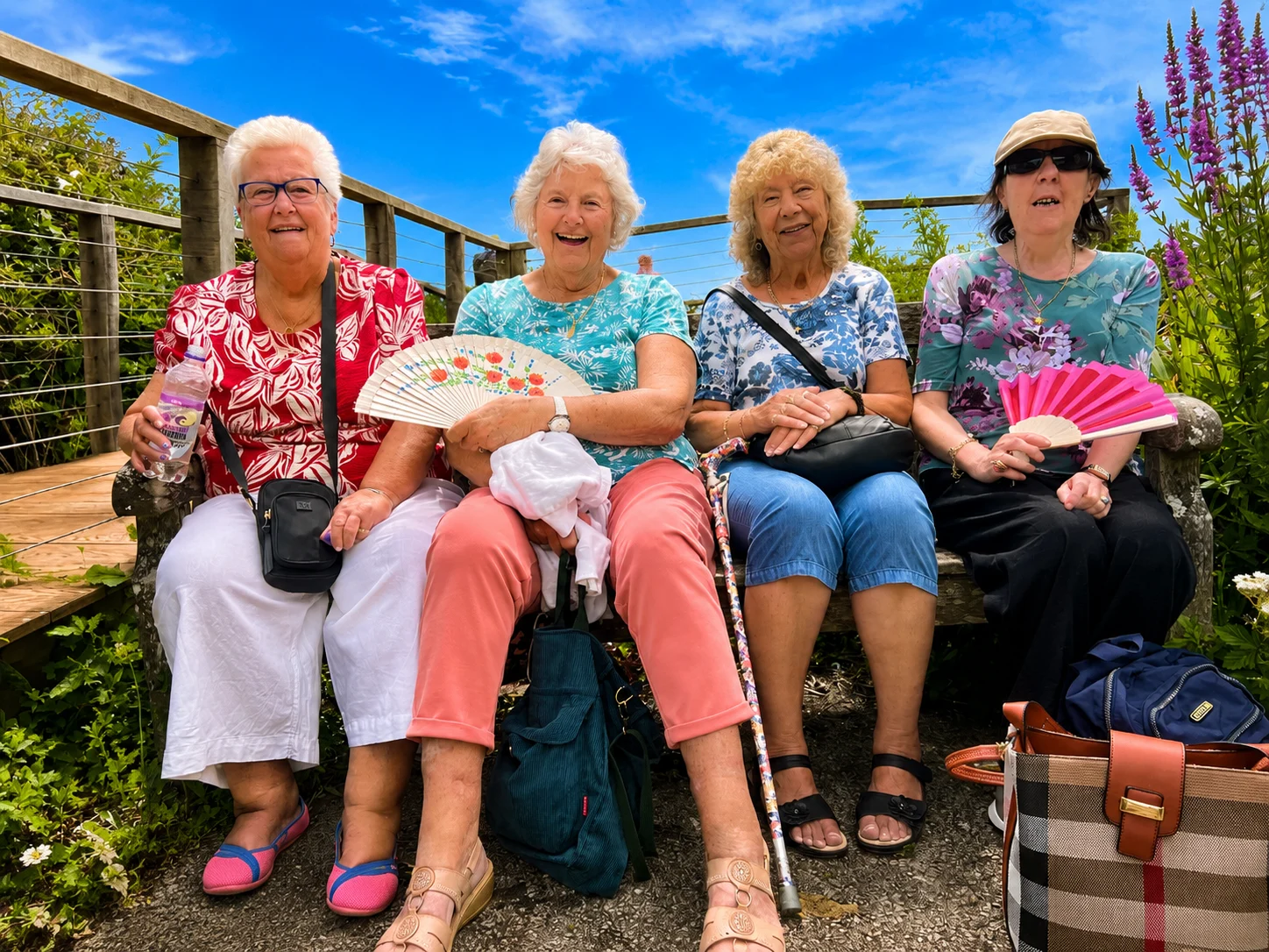 group of older women sitting outside in the sun